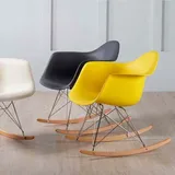 Mecedoras estilo Eames en blanco, negro y amarillo, vistas en conjunto